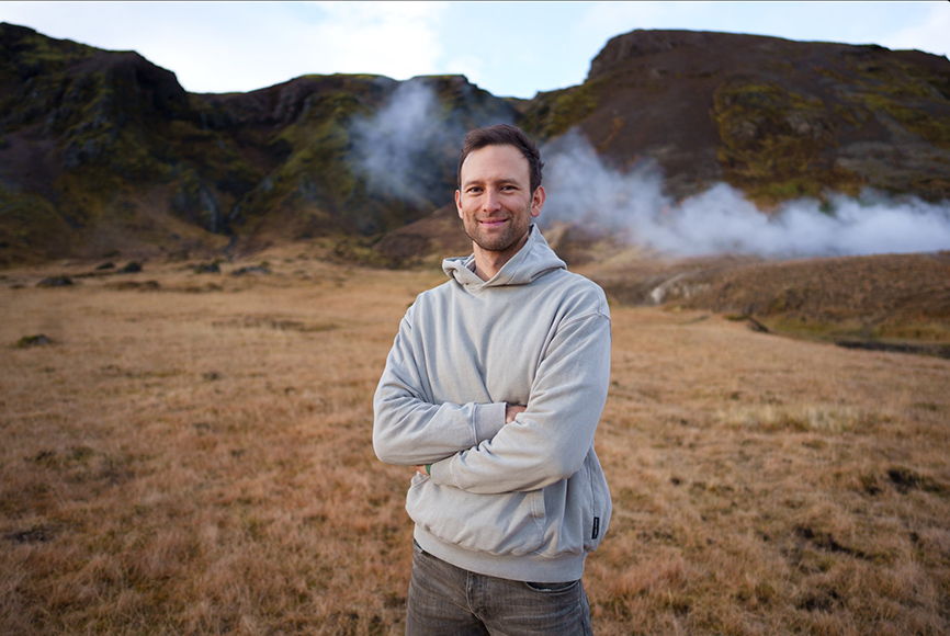 A man standing in a field with steam coming out of his ears.