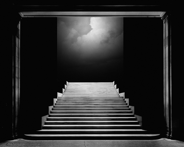 A black and white photo of a staircase in the dark.