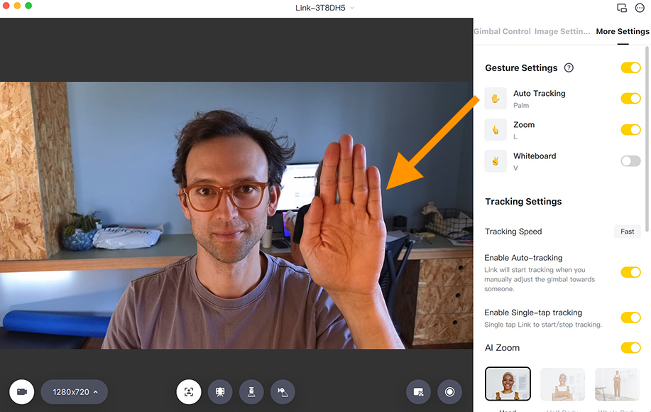 man testing webcam on Mac Mini by raising hand to focus