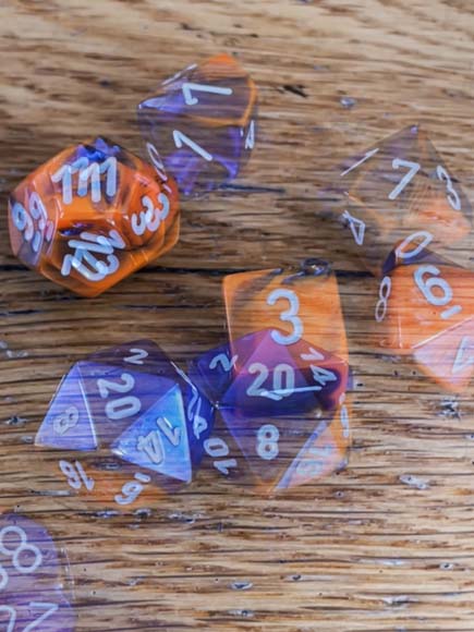 long exposure photo of a group of dice sitting on top of a wooden table.