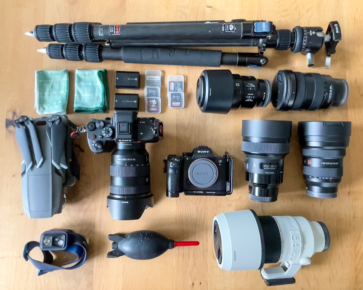 A collection of camera equipment laid out on a table.