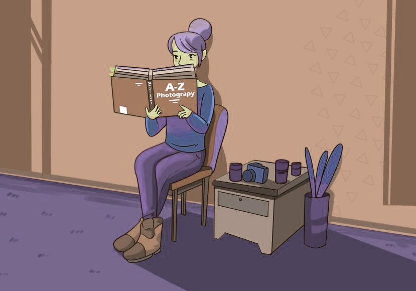 A girl is sitting on a chair reading a book.