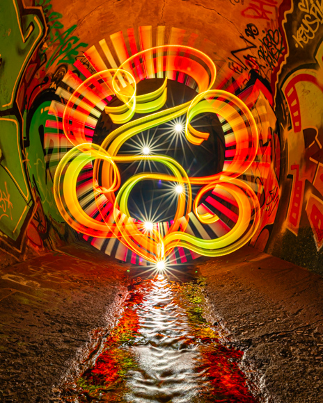 A light painting of a street sign in a tunnel.