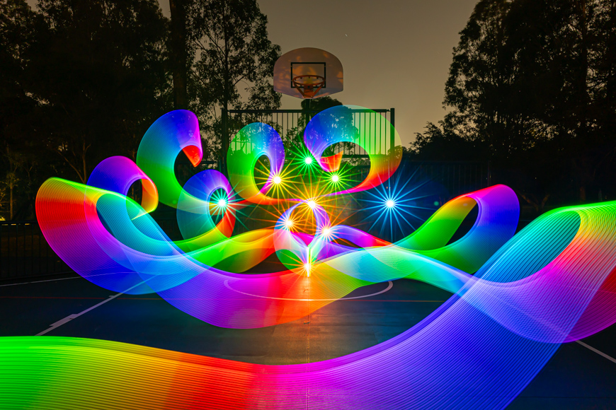 A light painting on a basketball court.