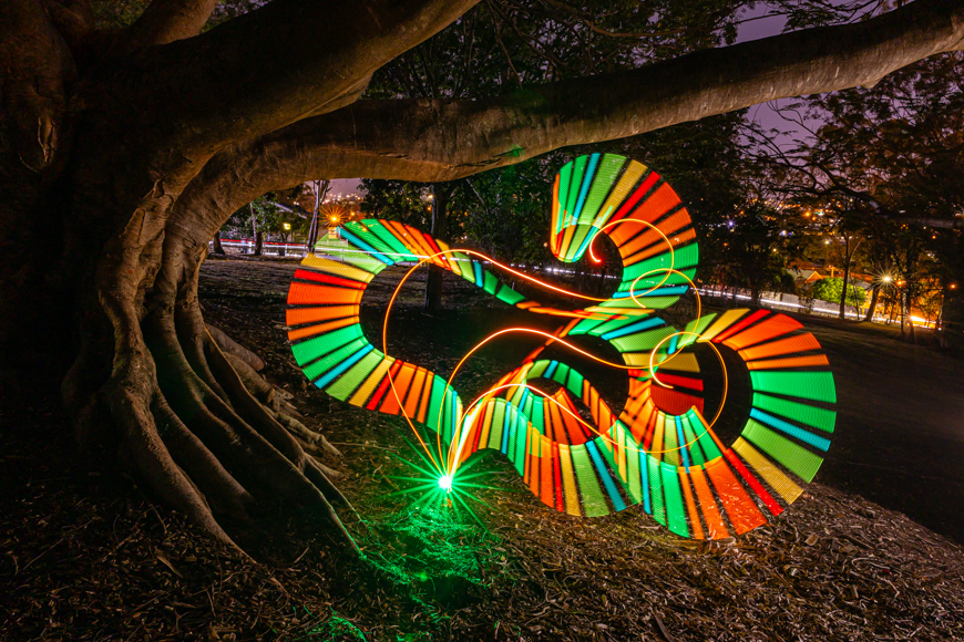 A colorful light painting on a tree.