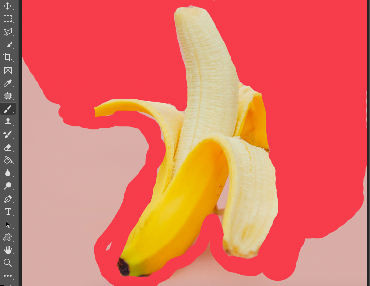 A banana with a red background in adobe photoshop.