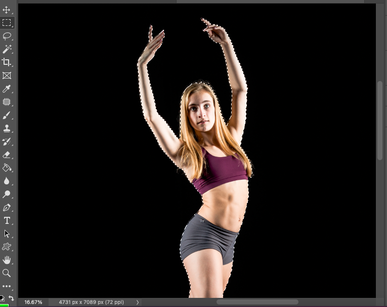 A photo of a woman posing in front of a black background.